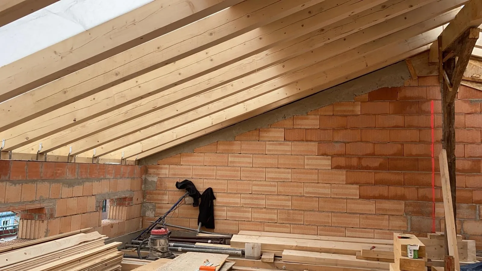 Attic conversion: new rafters and gable masonry