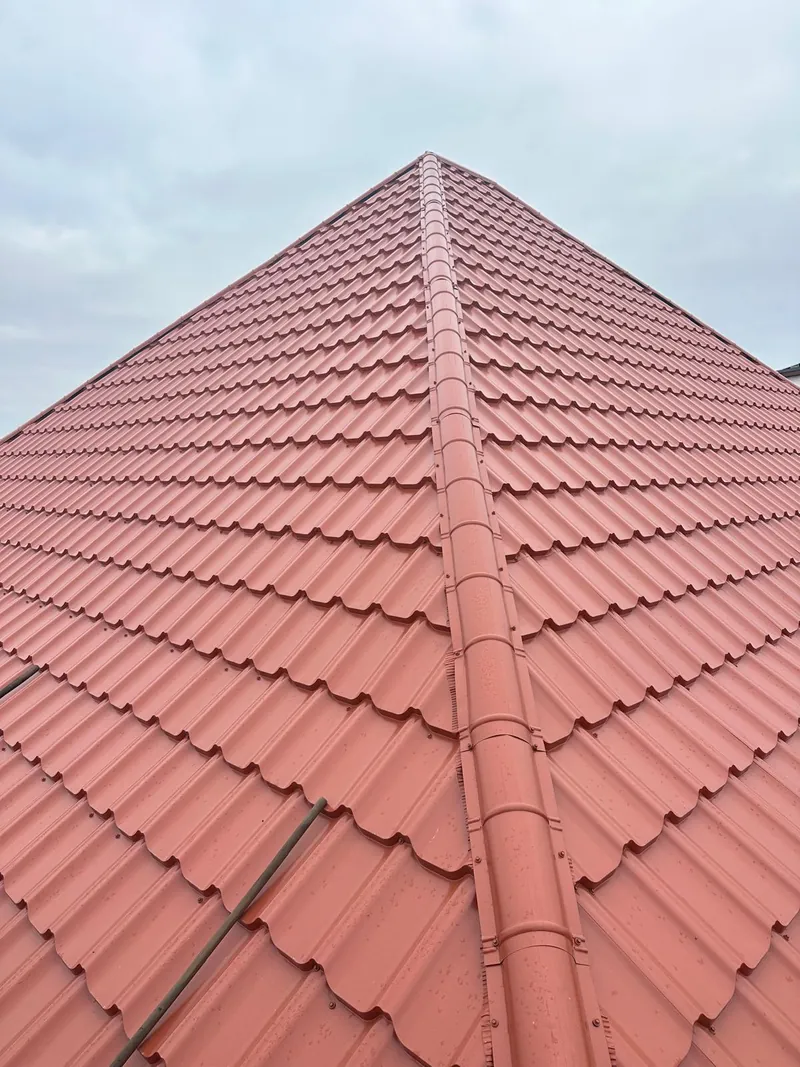 Ridge with red tile-effect metal sheets