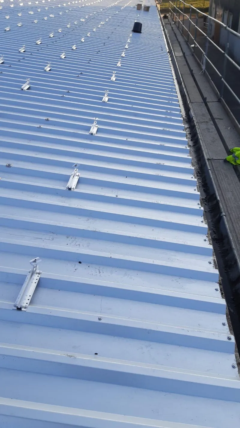 Mounting rails for solar modules on trapezoidal sheets